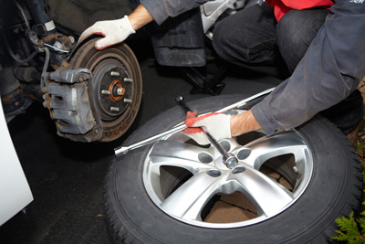 Mechanic changing tire Mechanic changing tire